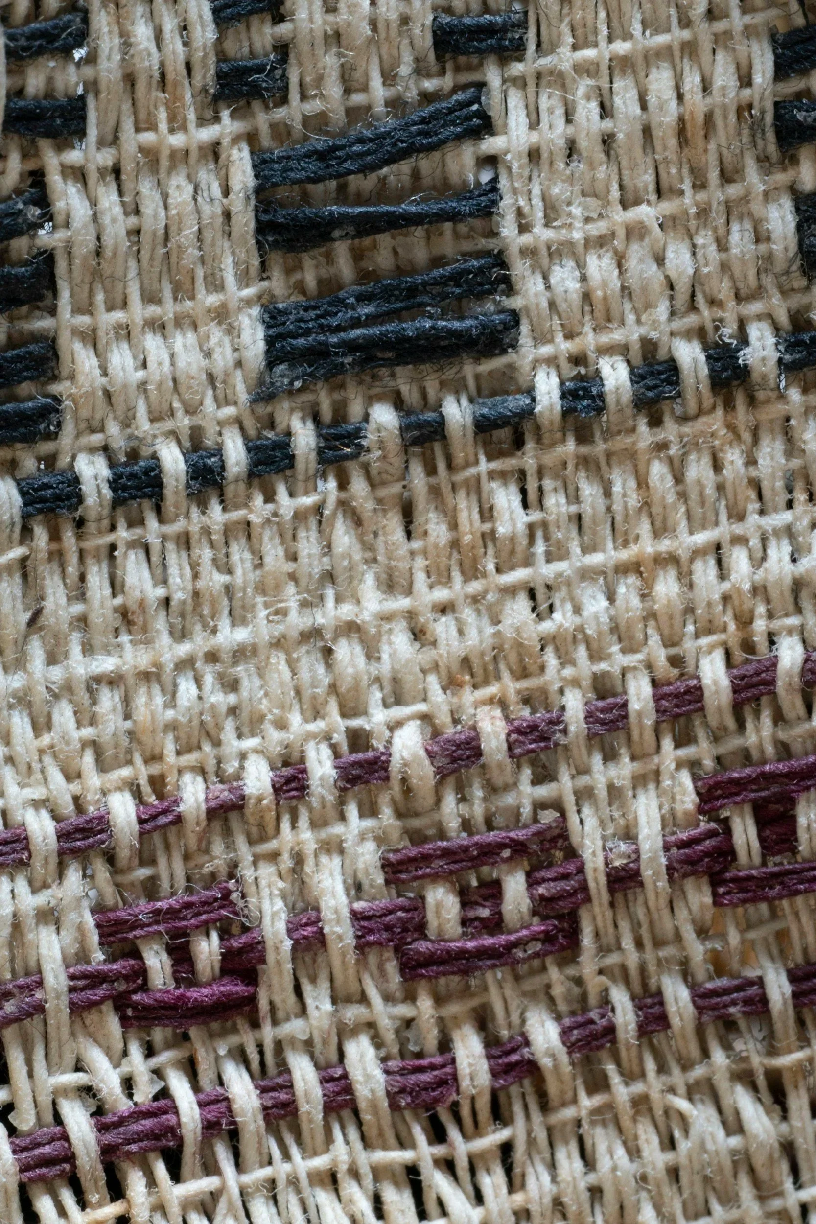 Close-up of a brightly colored woven blanket with visible stitching, symbolizing connection, family, and the patterns we inherit.