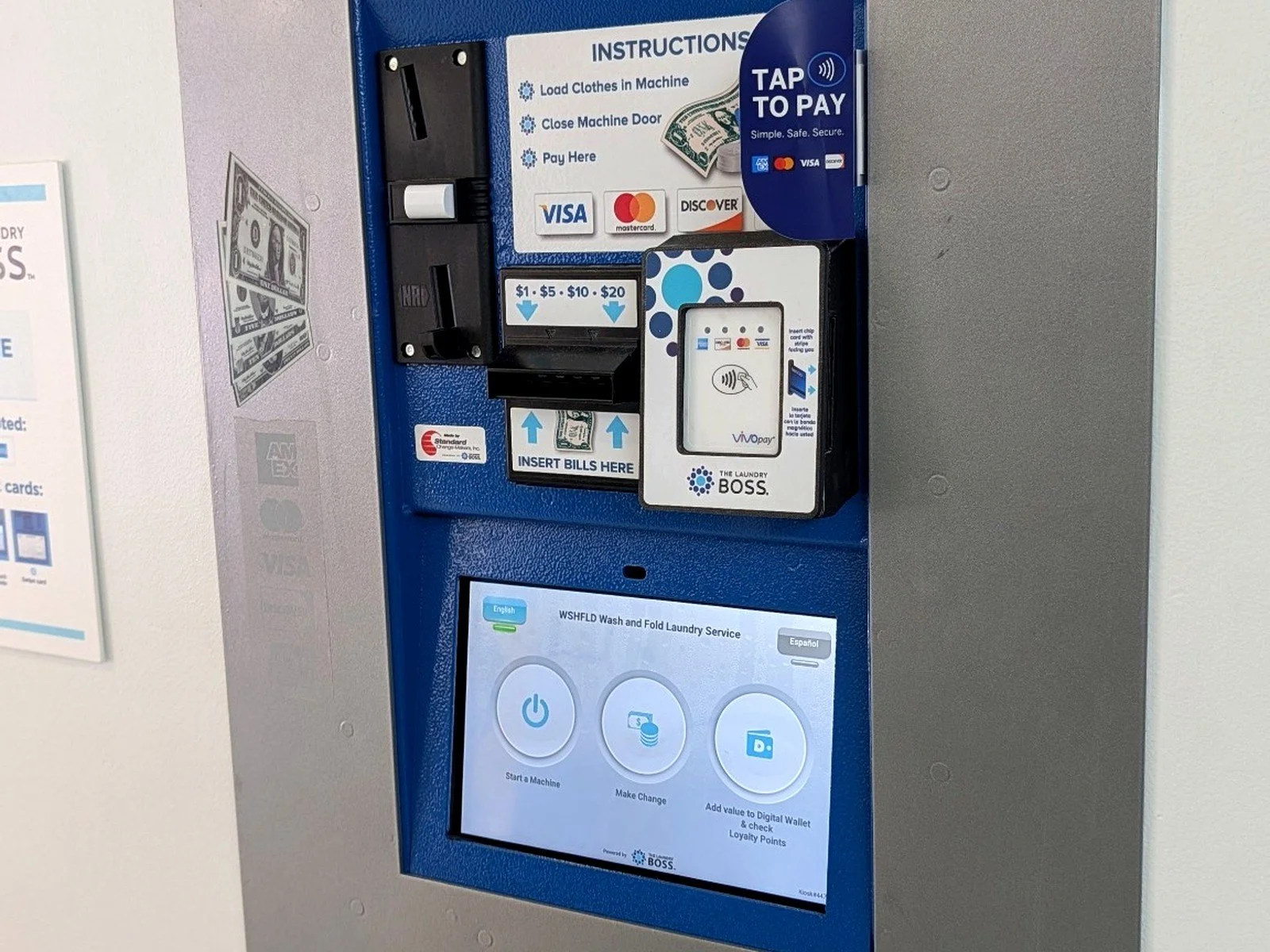 WSHFLD Laundry payment station accepting cash, card, and tap-to-pay, with touchscreen controls for starting machines and adding account value.