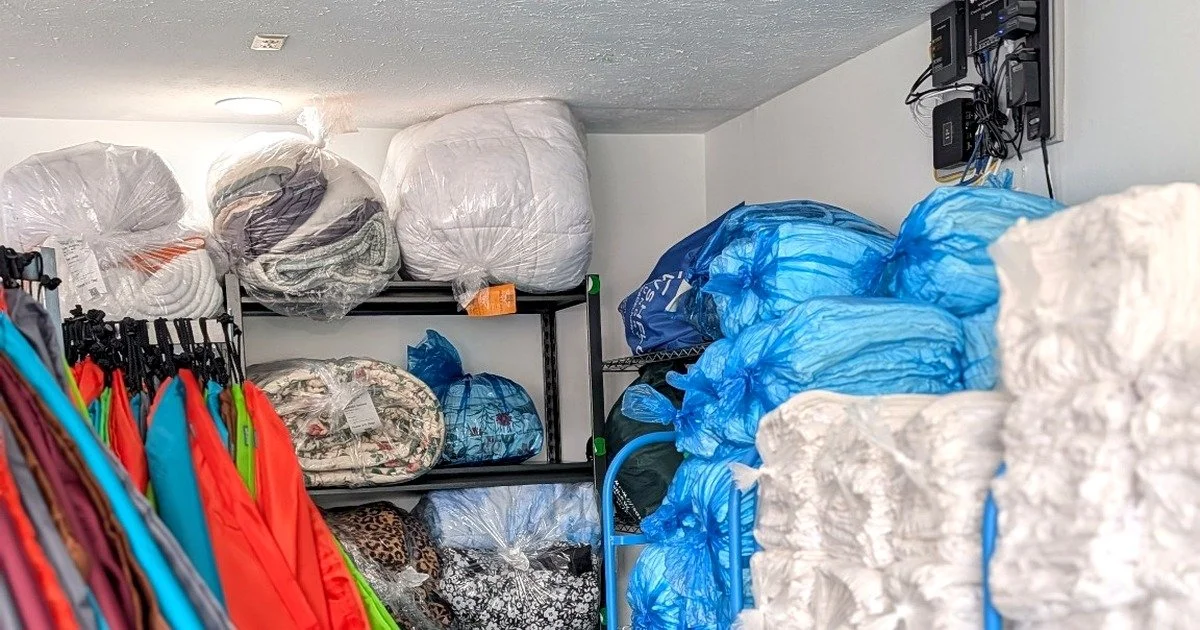 Commercial linens, laundry bags, and garments organized for processing, pickup, or delivery by WSHFLD Laundry.