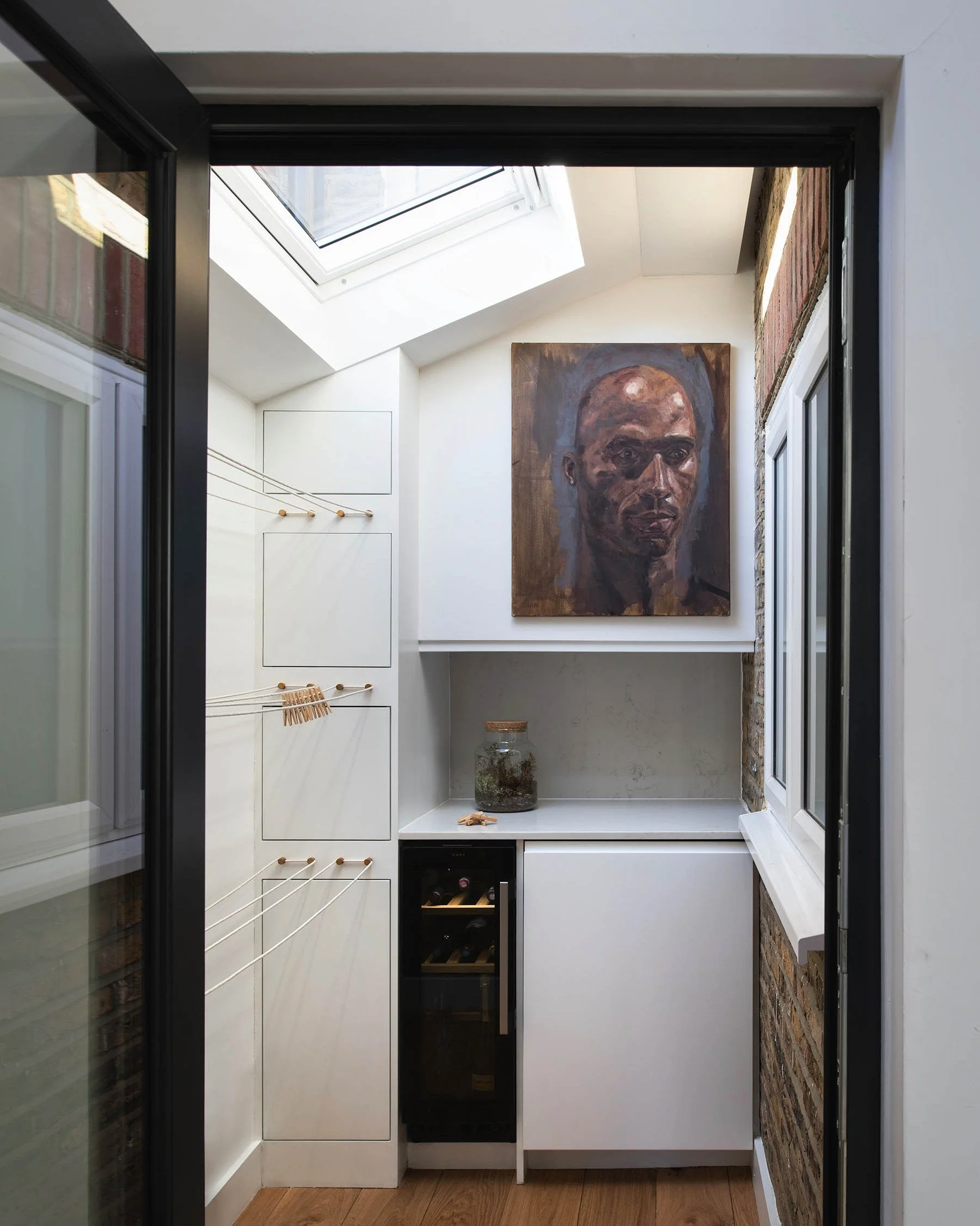 Every home carries quiet opportunities. Here, a forgotten 1.3 x 2.1m void became a warm, practical laundry room, flooded with natural light, softened by indirect cove lighting and grounded by the original brick with a new timber floor. A small footpr