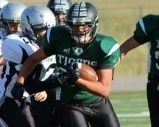 student playing football