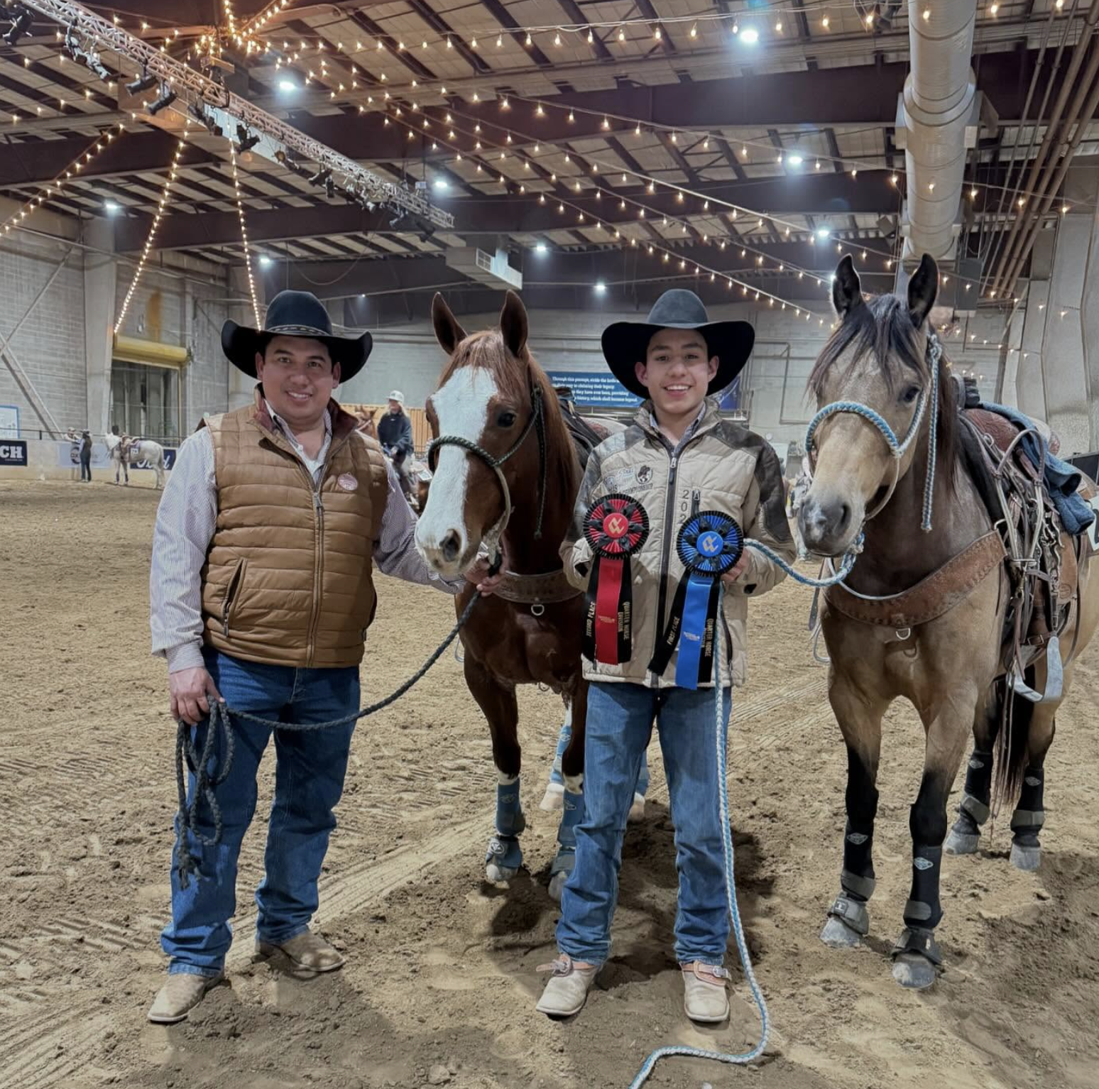 student holding winning ribbons at rodeo competition