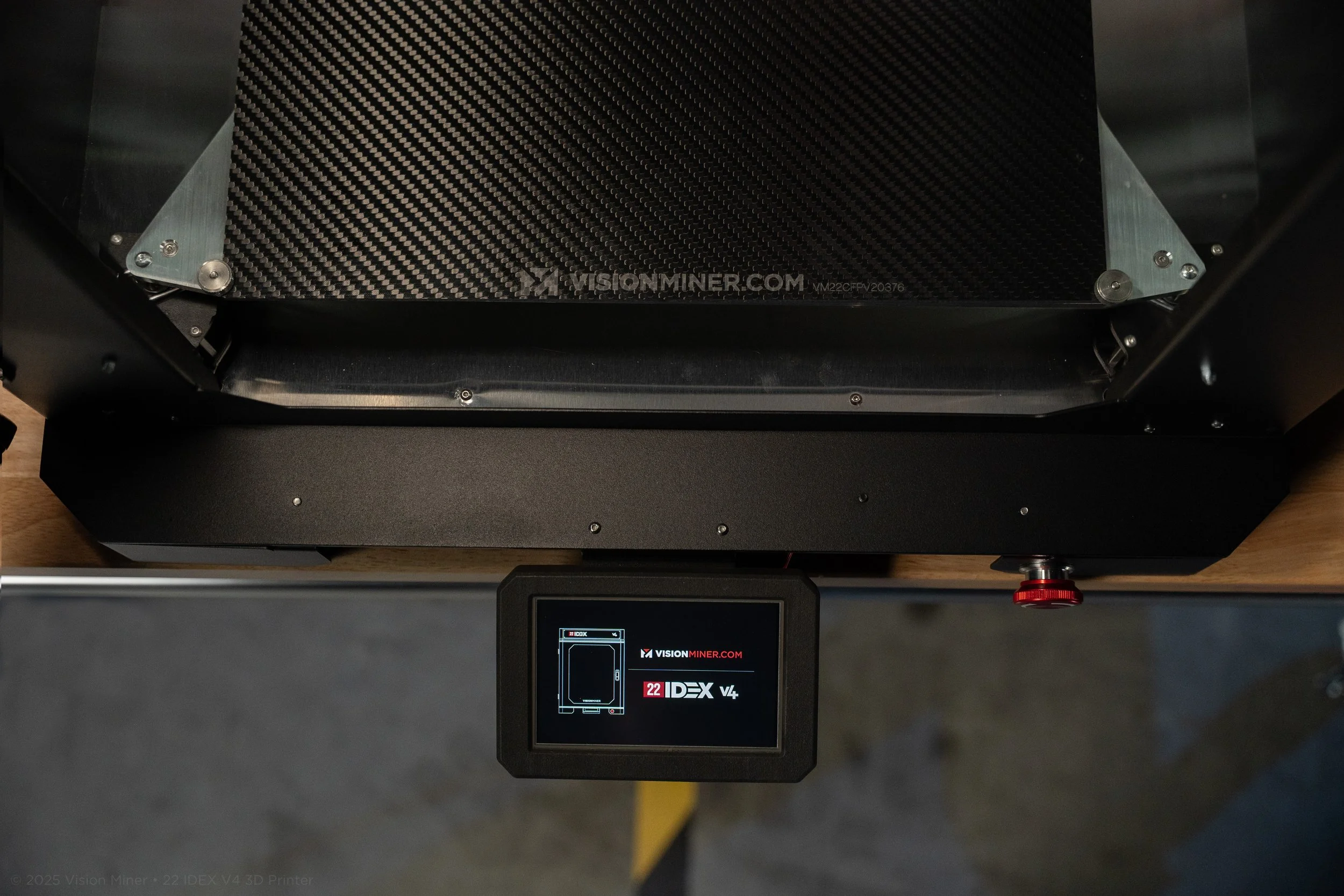 Top view of a 3D metal printer with a digital screen displaying the brand VisionMiner and model 22 IDEX V4.