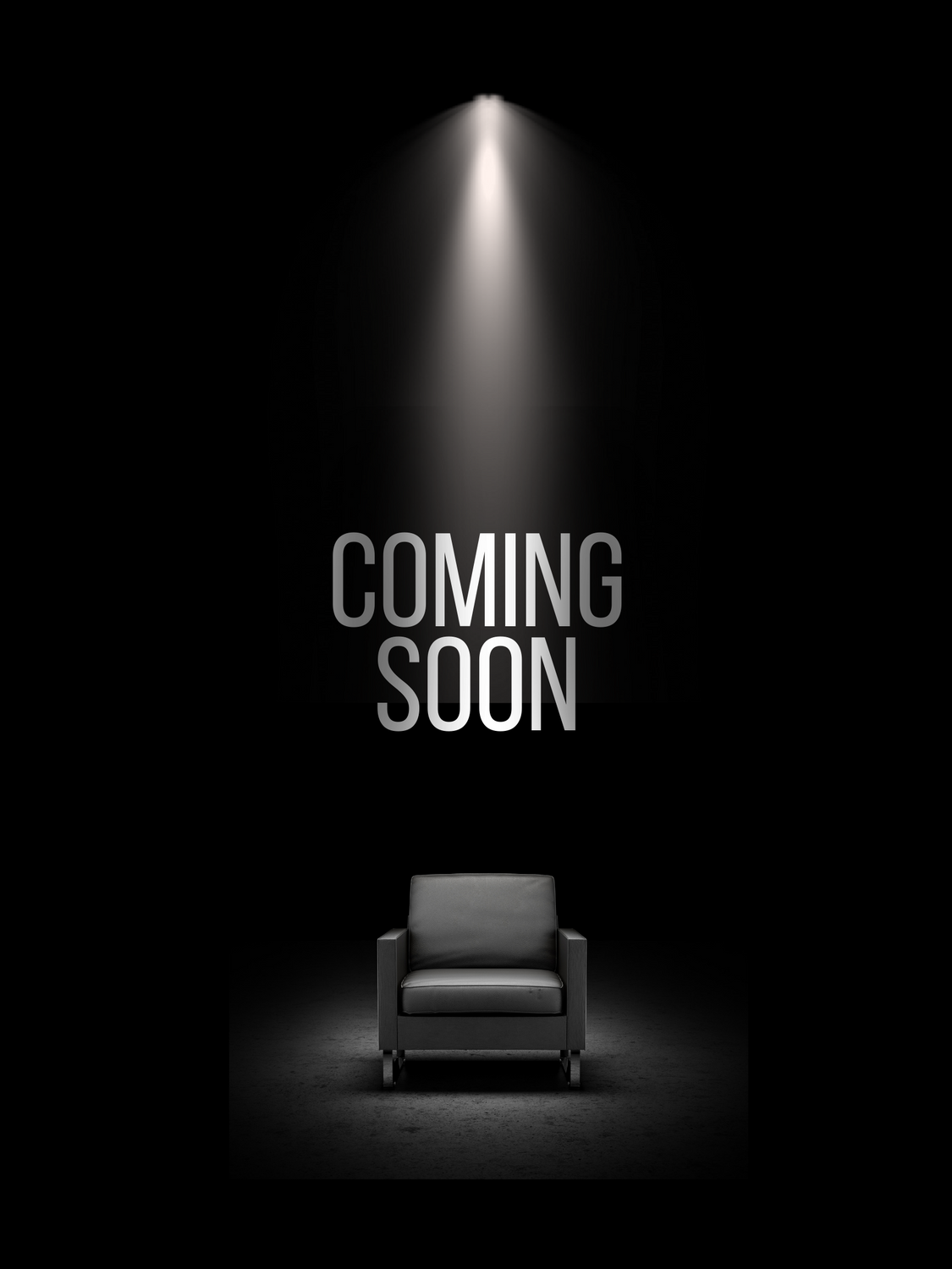 Dark room with spotlight shining on a single black armchair, with the words 'Coming Soon' in gray text above the chair.