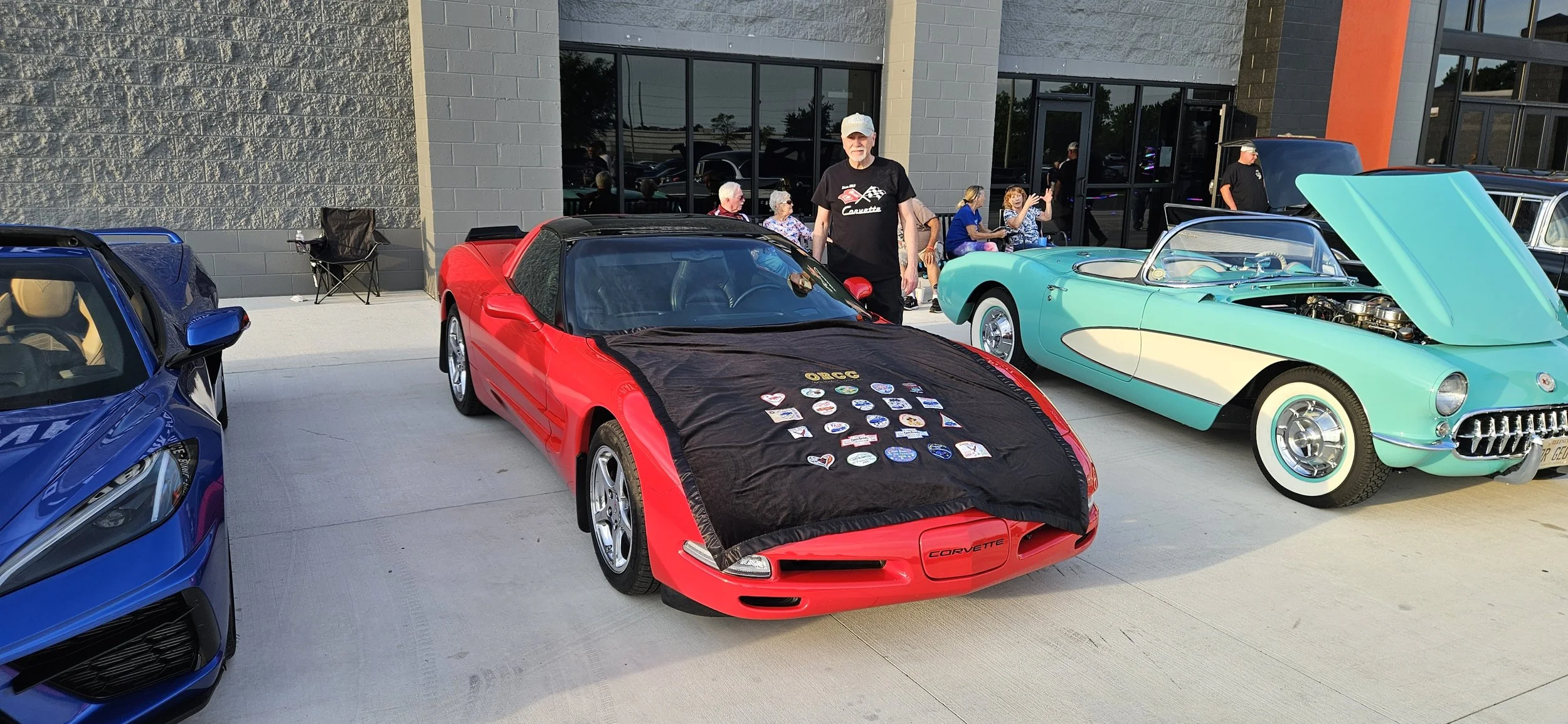 Dennis won the door prize of a Open Roads Corvette Club throw with a display of Club Event Patches. 