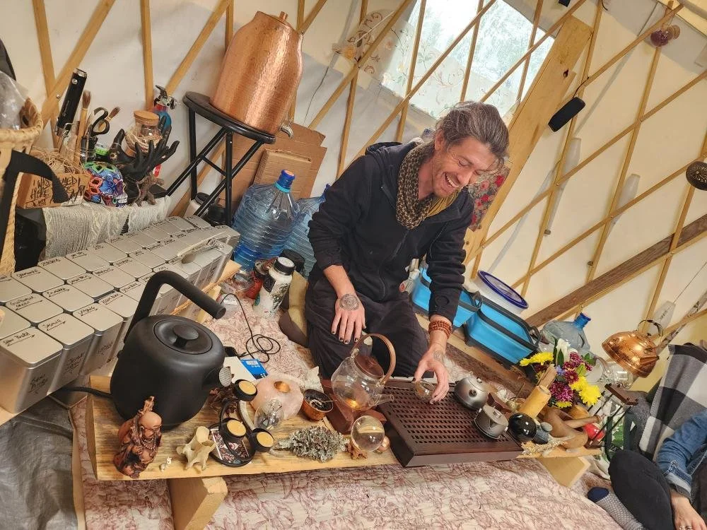 Iroh founder, Noah Schoneberg serves tea in their pop up yurt at Maine Fungi Fest