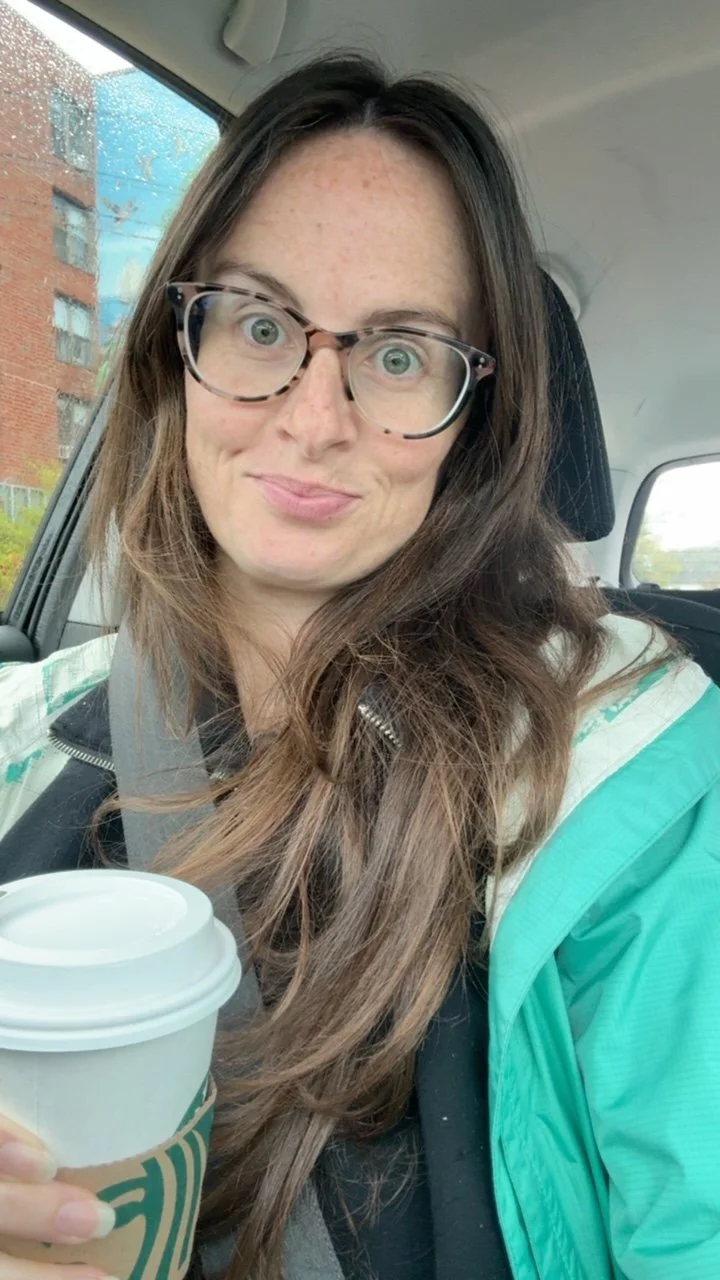 shannon drinking a tea in the car