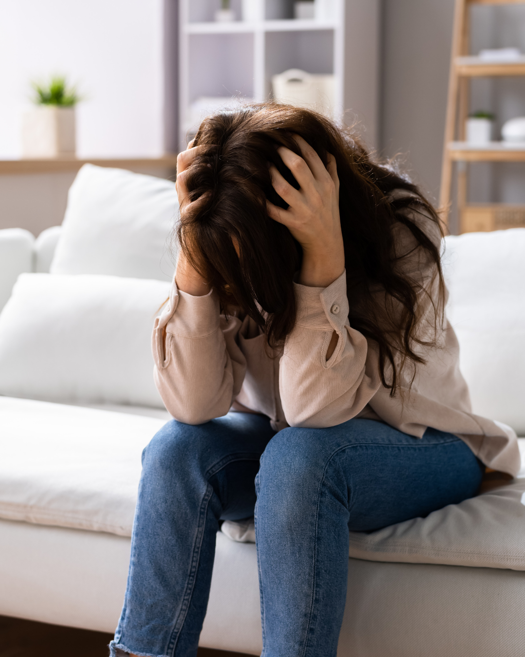 woman struggling with OCD on her couch