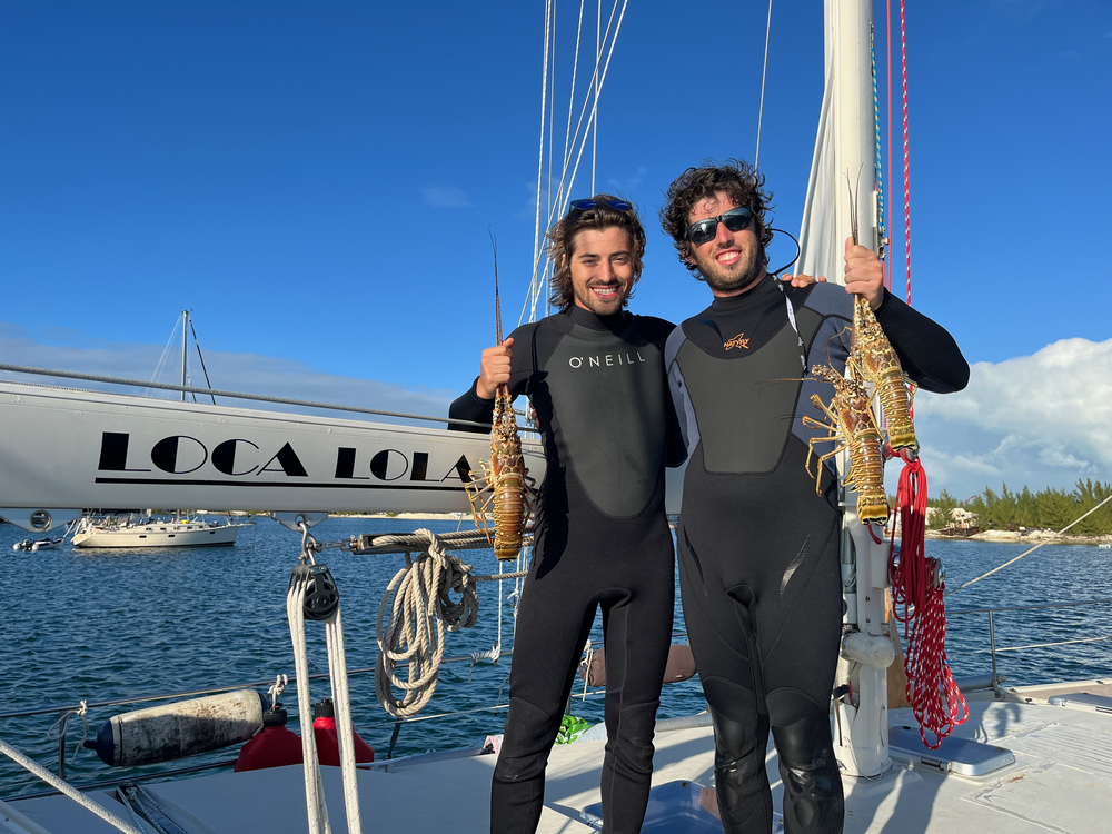 Andrew and his brother Ryan with fresh-caught spiny lobsters in Bimini, Bahamas