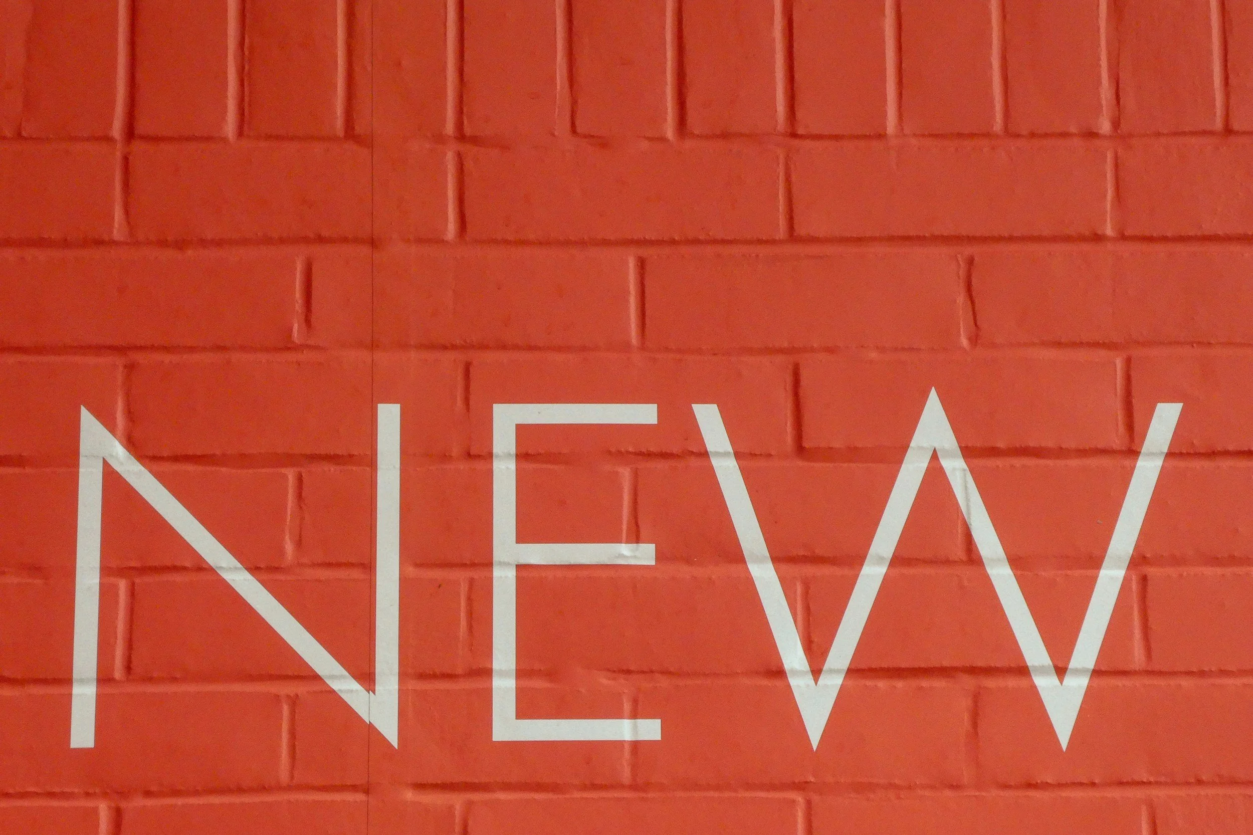 orange bricks with the word "new" in white
