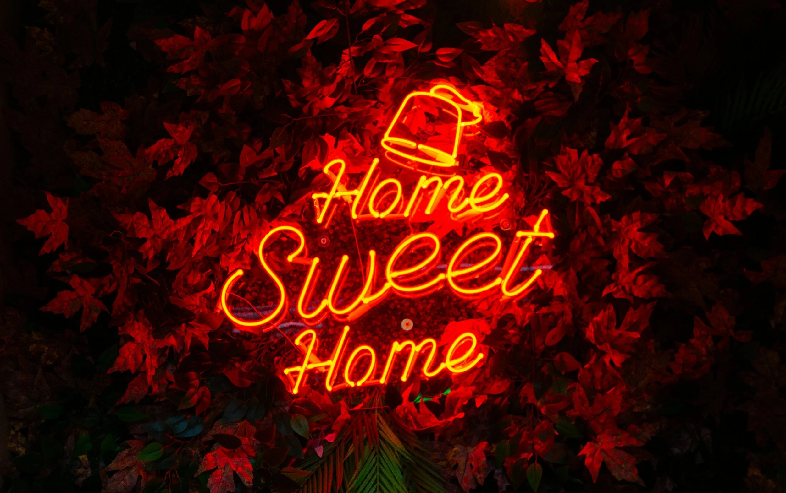 Image on black background with words Home Sweet Home in Neon Orange
