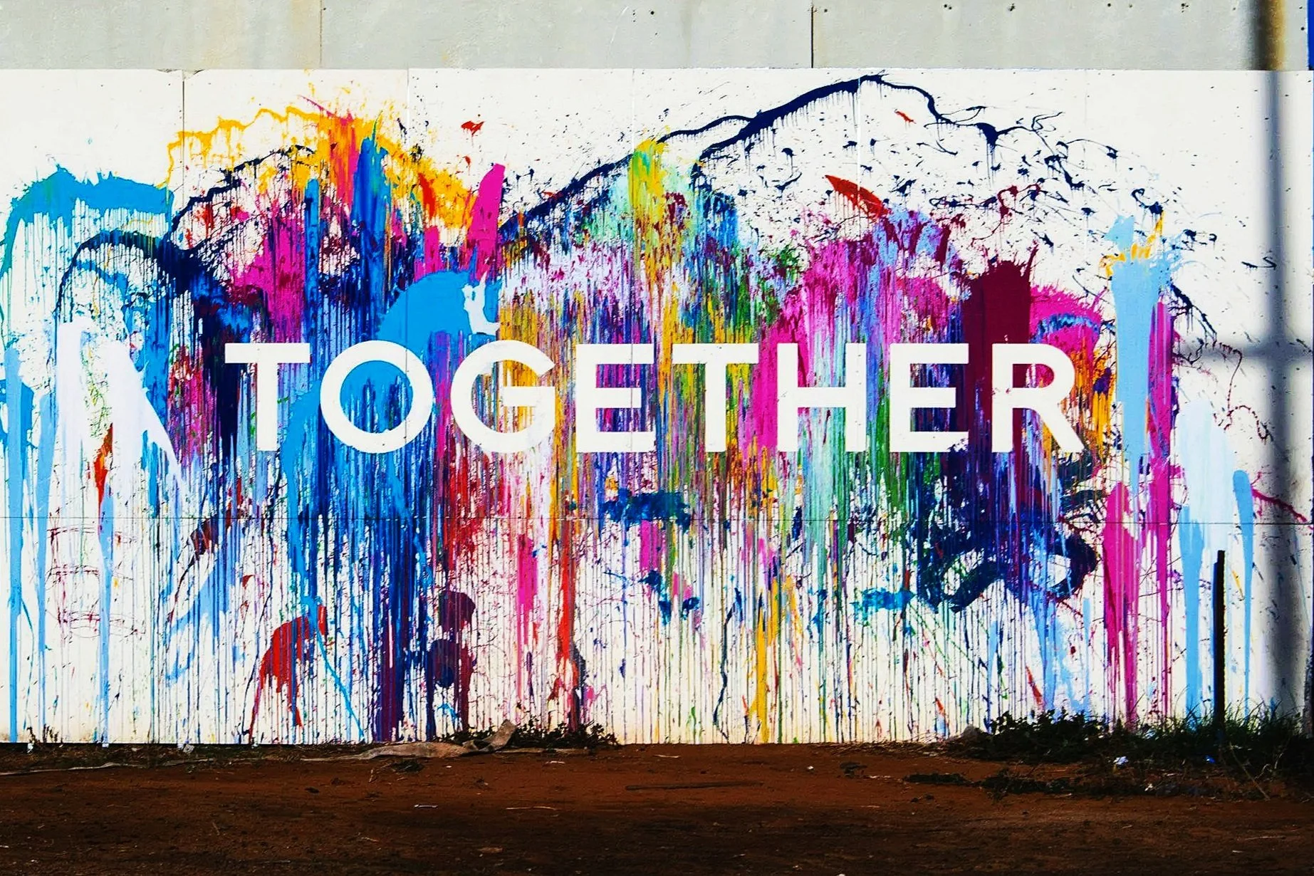 Colorful graffiti wall with the word 'TOGETHER' in white letters.