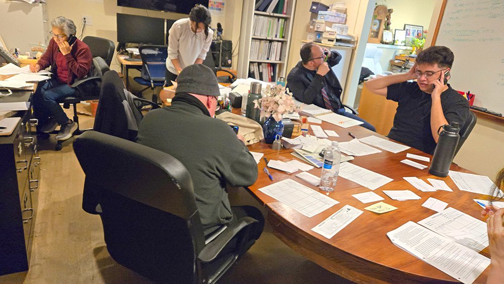 A group of volunteers making phone calls.