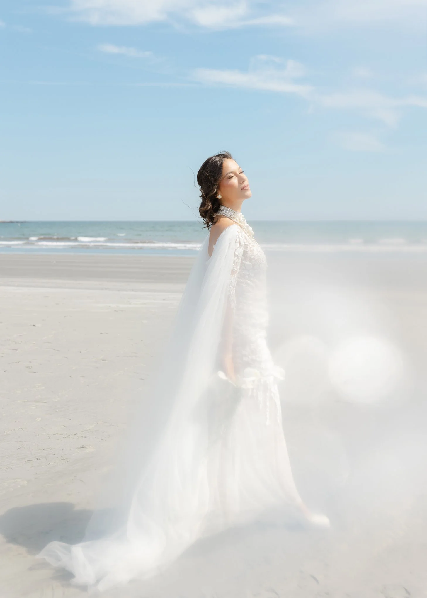 Bride walking on the beach in Newport Rhode Island on her wedding day