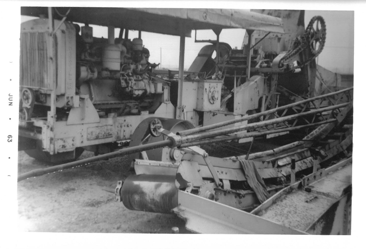 Black and white photo of large military or industrial machinery with various gears, belts, and conveyor belts.