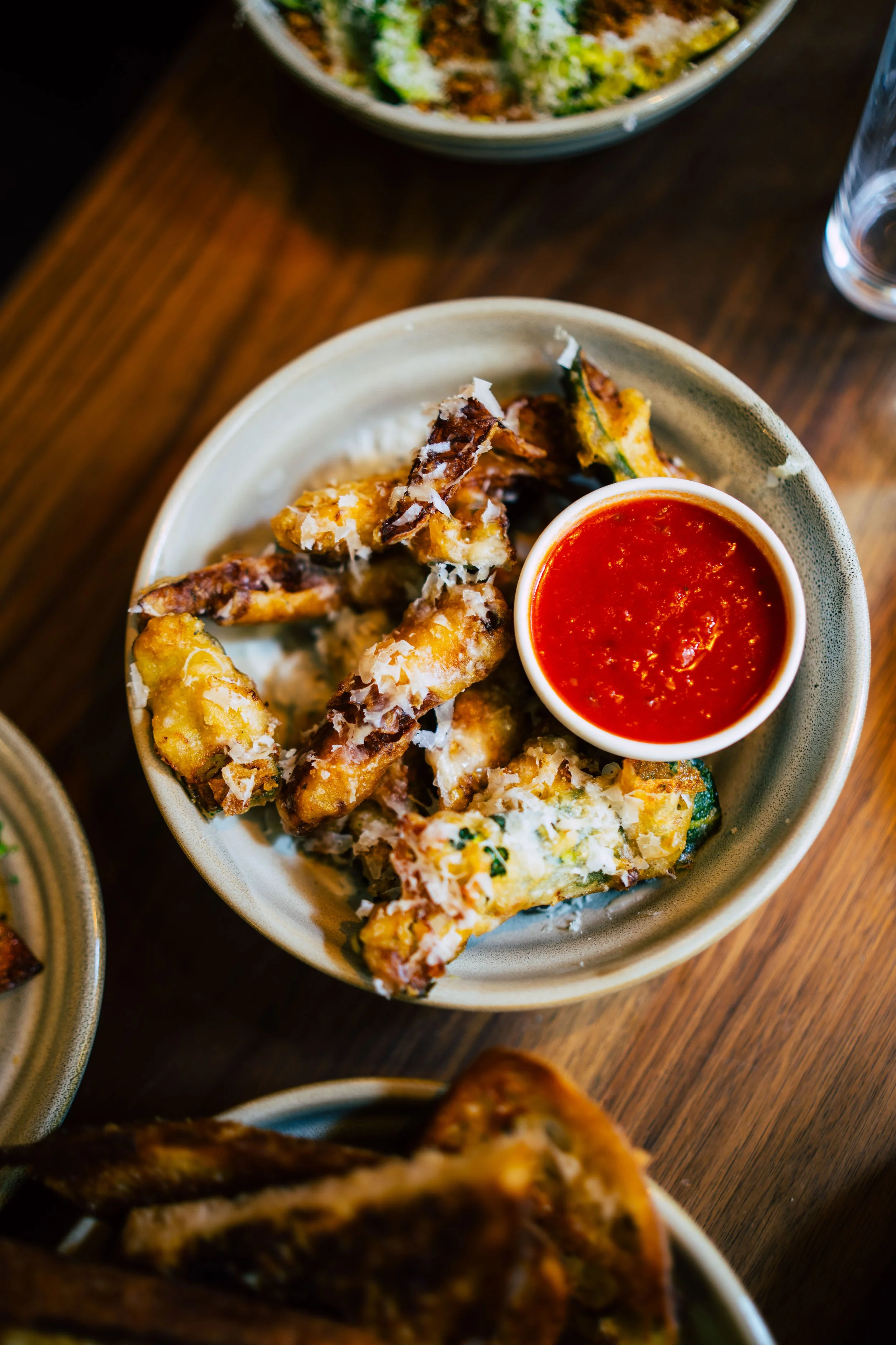 Plates of food on a wooden table.