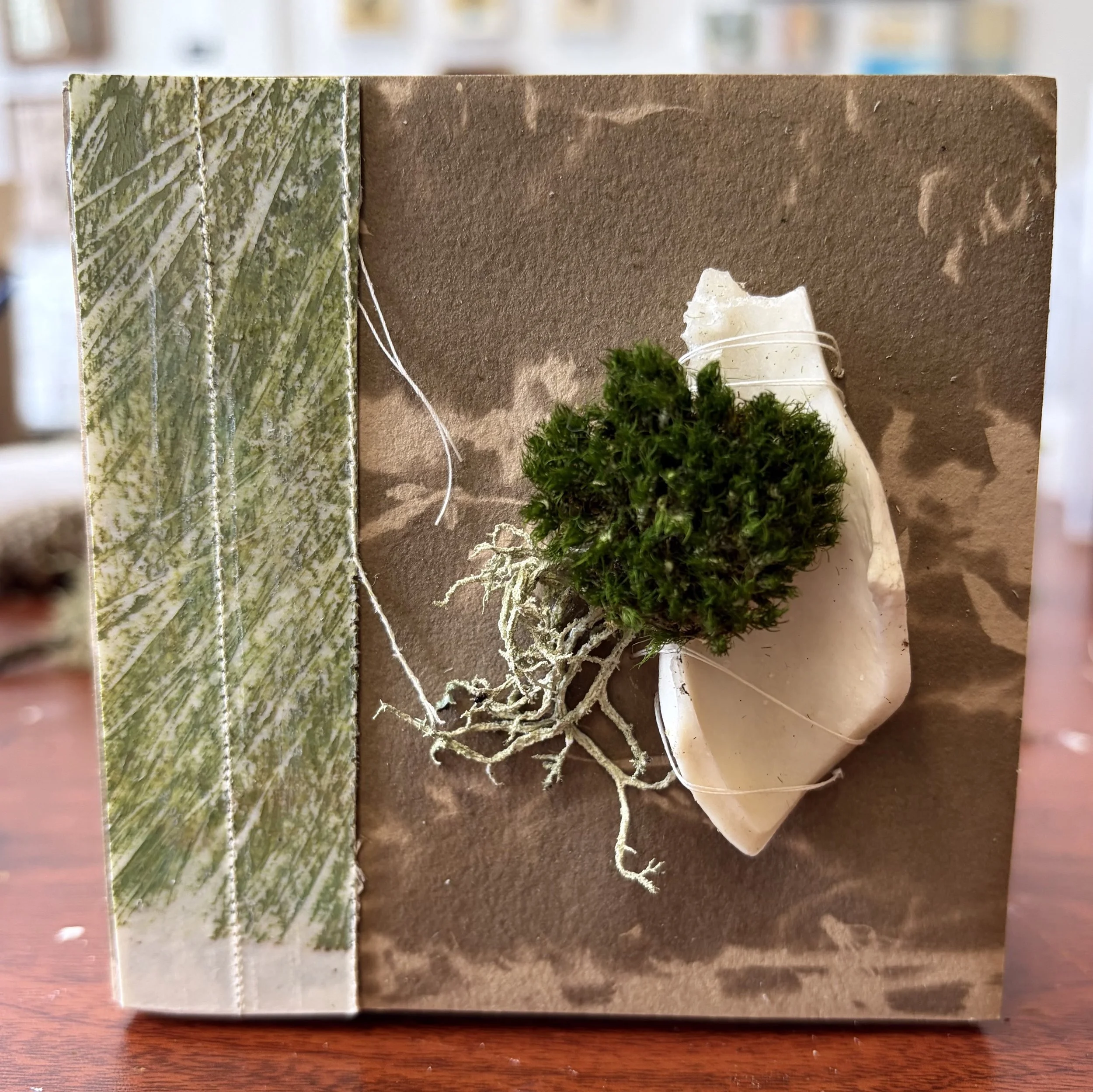 Moss + Bone, 2026
mixed media, monoprinting, beeswax, stitching, tannin-toned cyanotype, found objects, acrylic
4" x 4"
$100