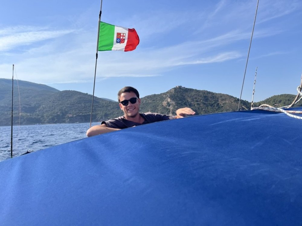 Luca aboard a sailboat in Italy
