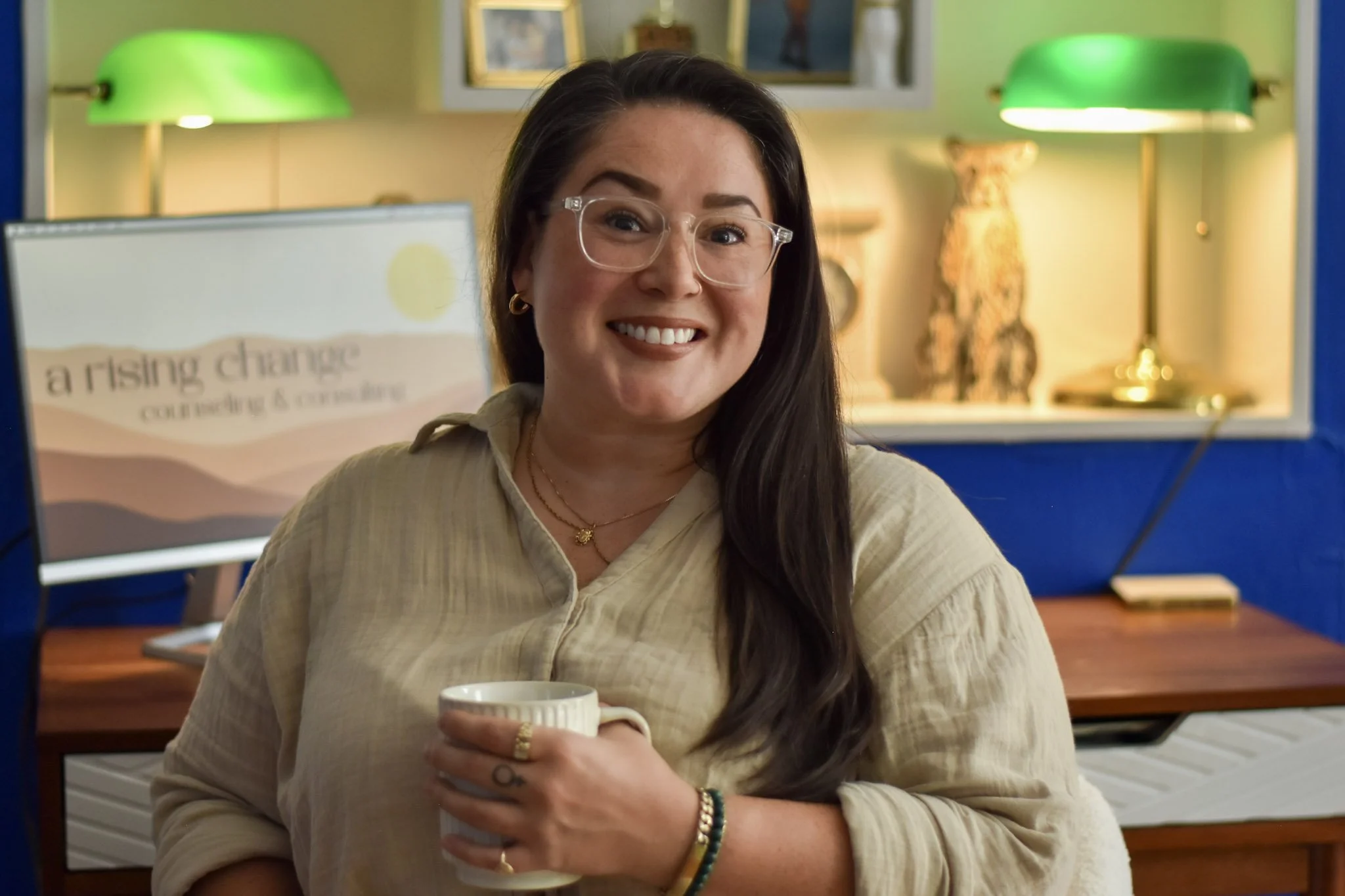 Savannah Helton sitting in front of A Rising Change therapy design