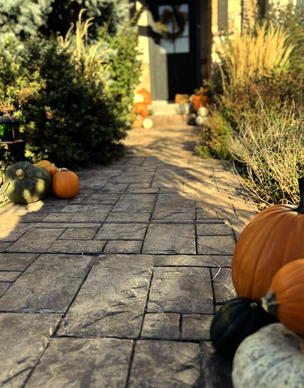 “Stone walkway decorated with pumpkins leading to front porch in Courtenay BC by Patch to Porch”