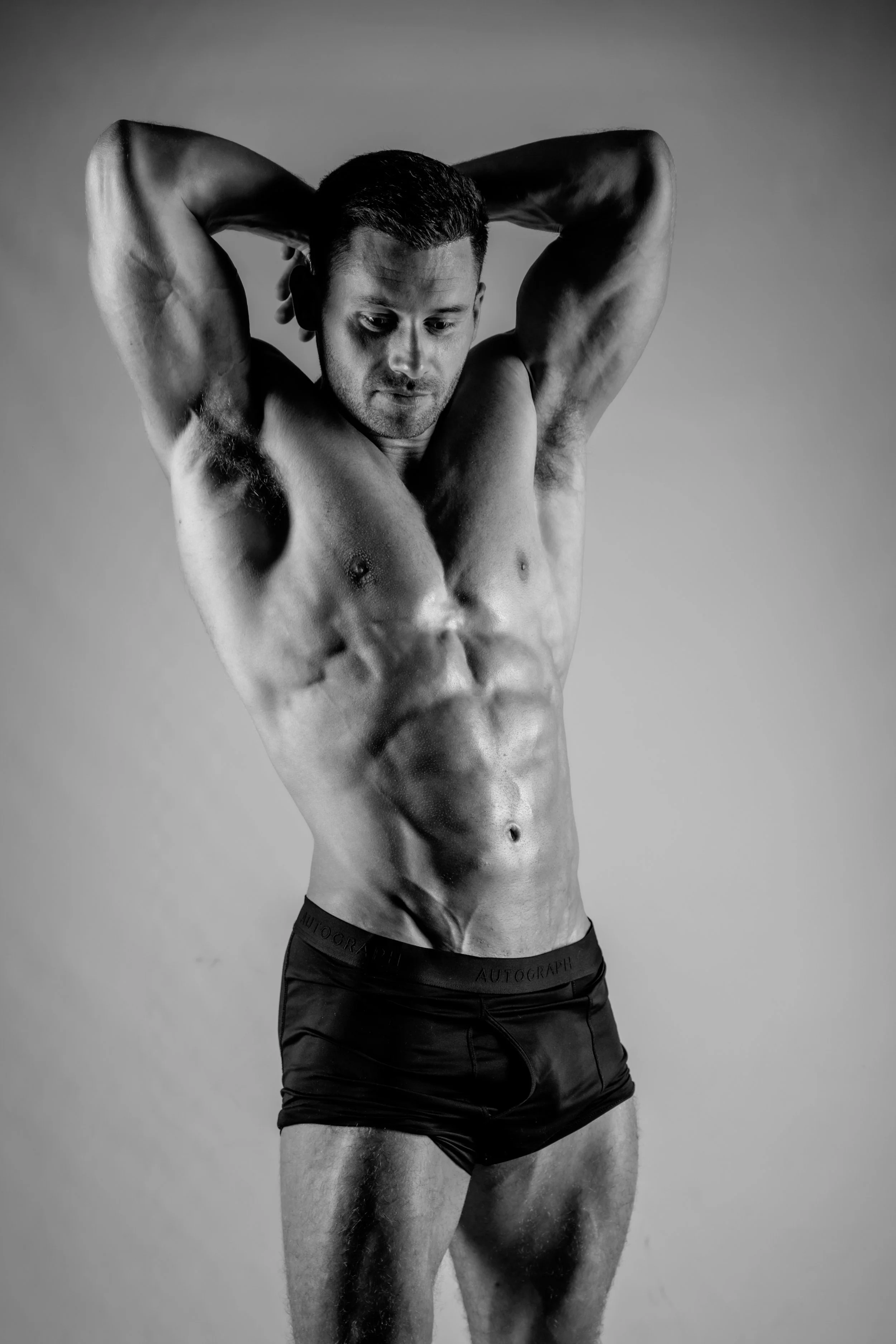 Posing physio man in black and shite. Muscular and lean