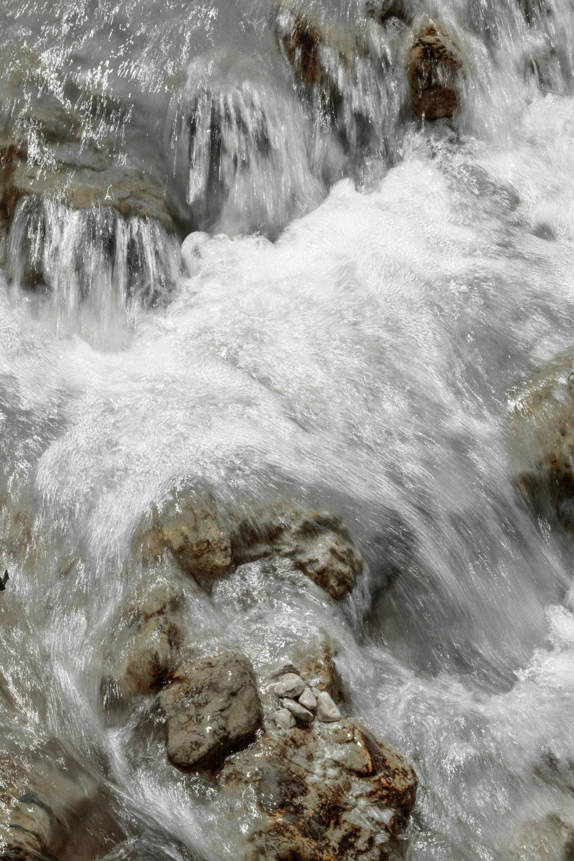Flowing river water over rocks and stones.