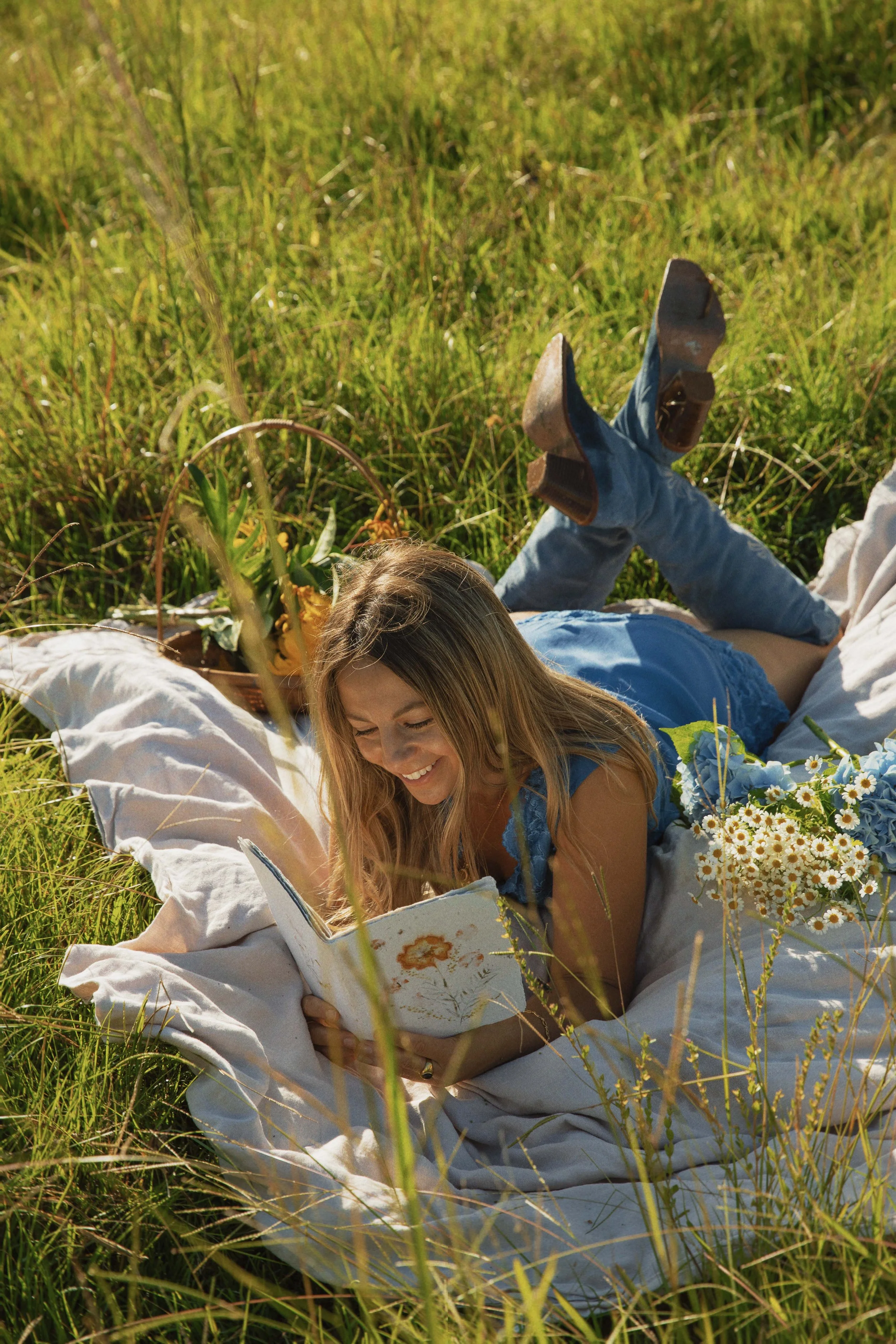 Sophie reading a book in a field