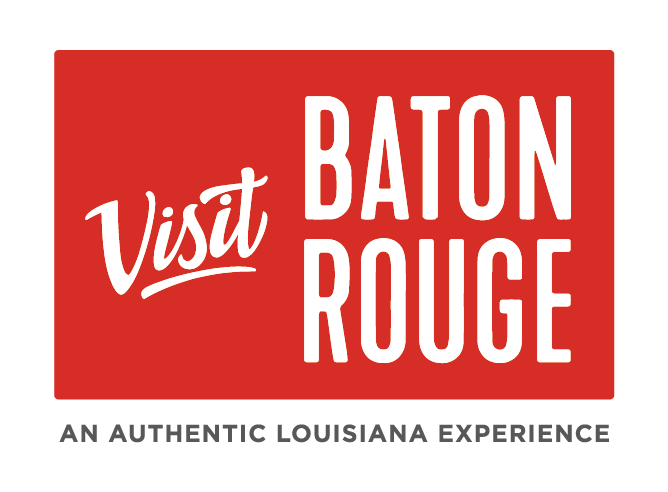 Red rectangular sign with white text that says, "Visit Baton Rouge," and smaller black text underneath that reads, "An authentic Louisiana experience."