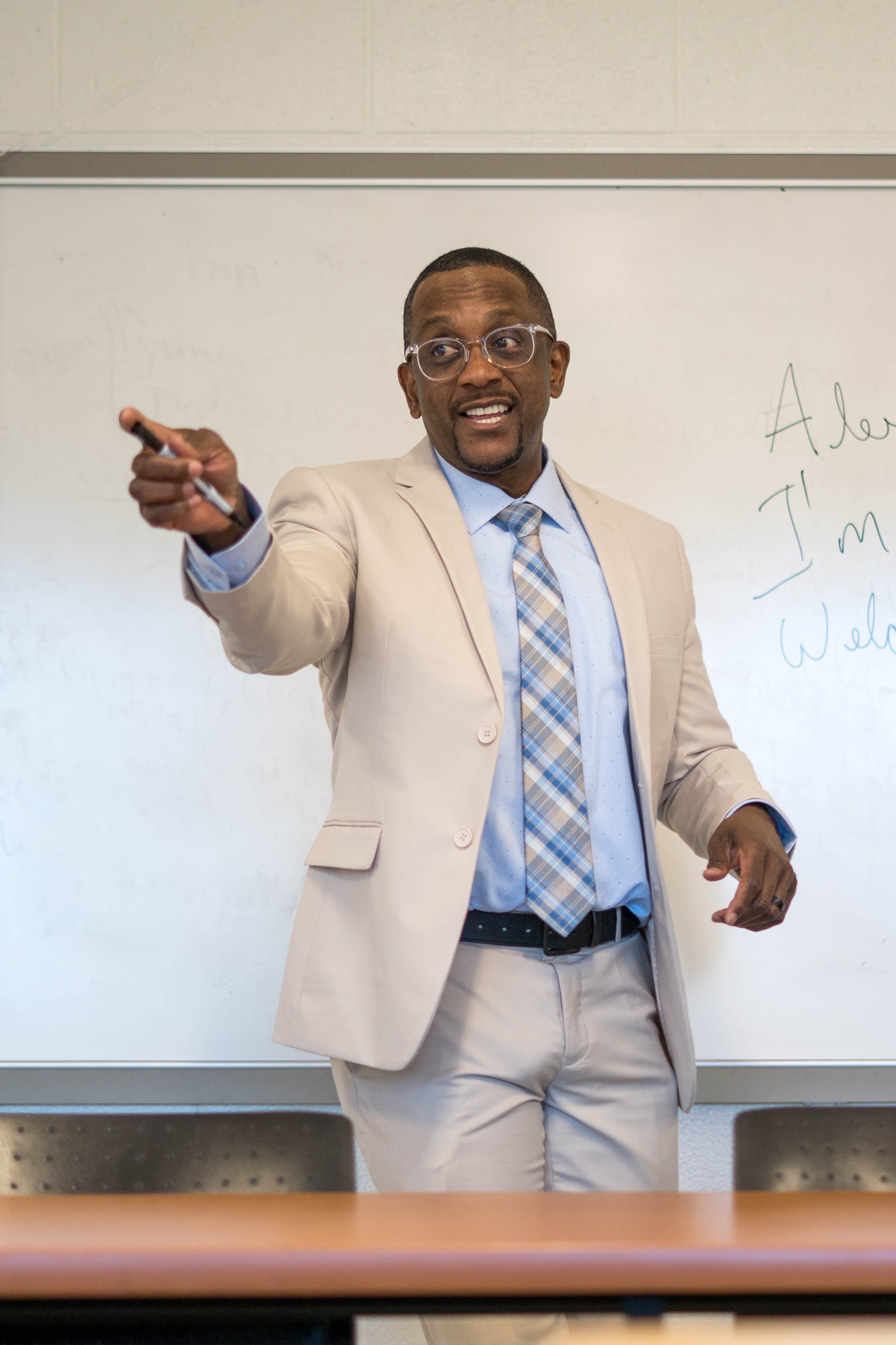 Alexander Scott delivering a lecture in a classroom.