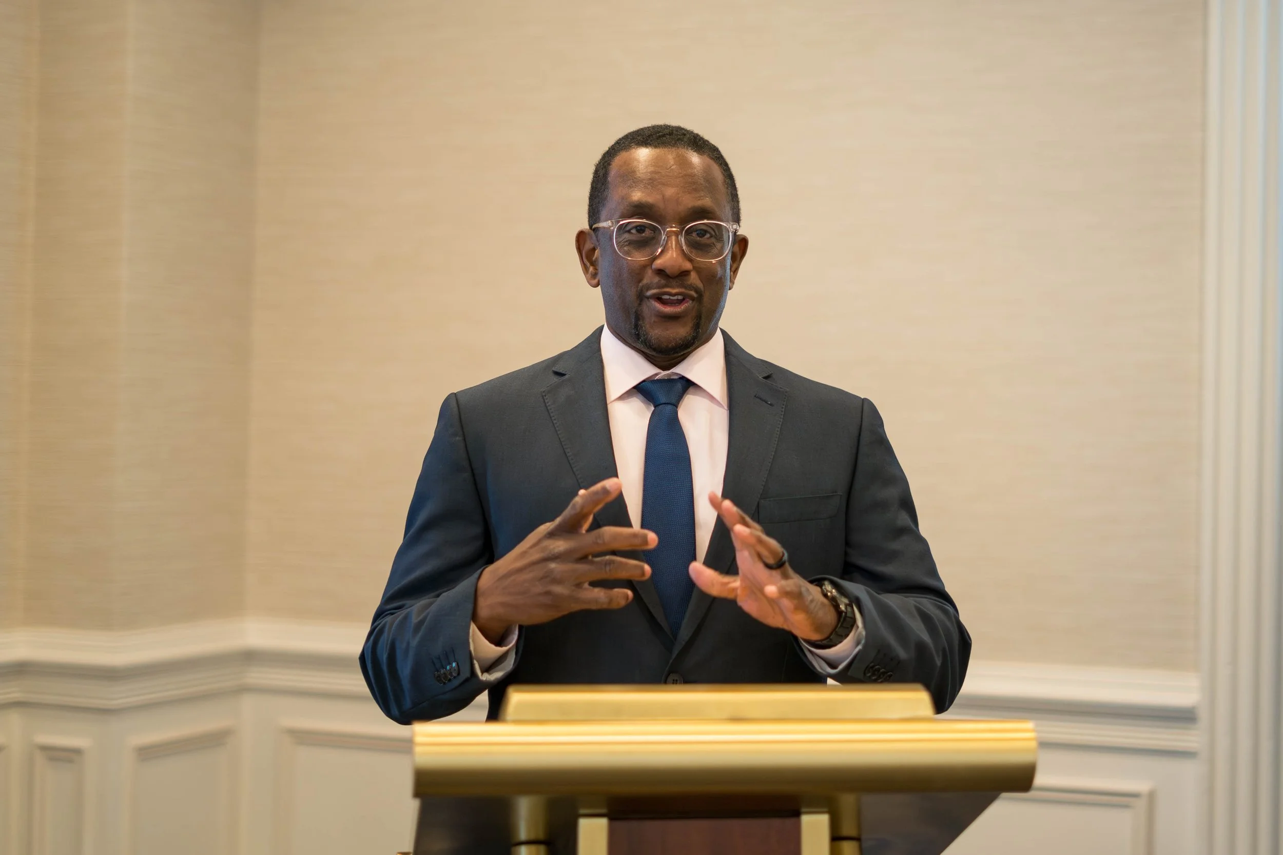 Alexander Scott giving a presentation at an academic leadership conference.