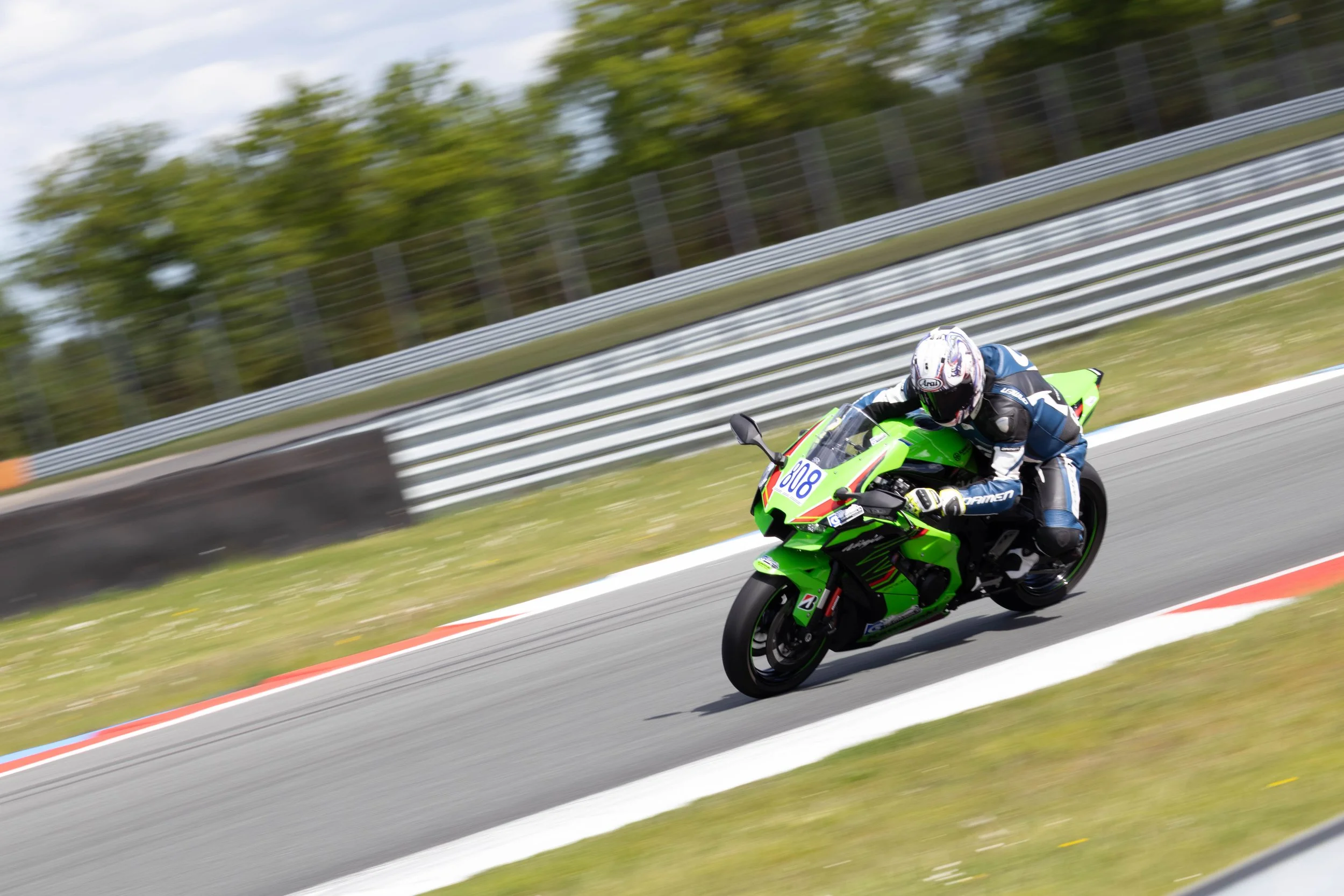 Motorcycle racer leaning into a turn on a racetrack