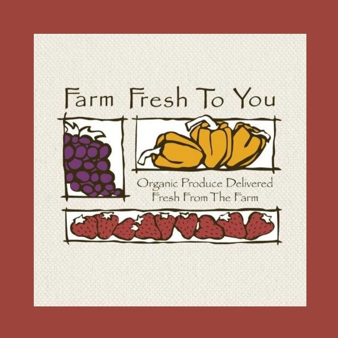 A sign promoting farm fresh produce with illustrations of grapes, yellow squash, and strawberries, along with the words "Farm Fresh To You" and "Organic Produce Delivered Fresh From The Farm."