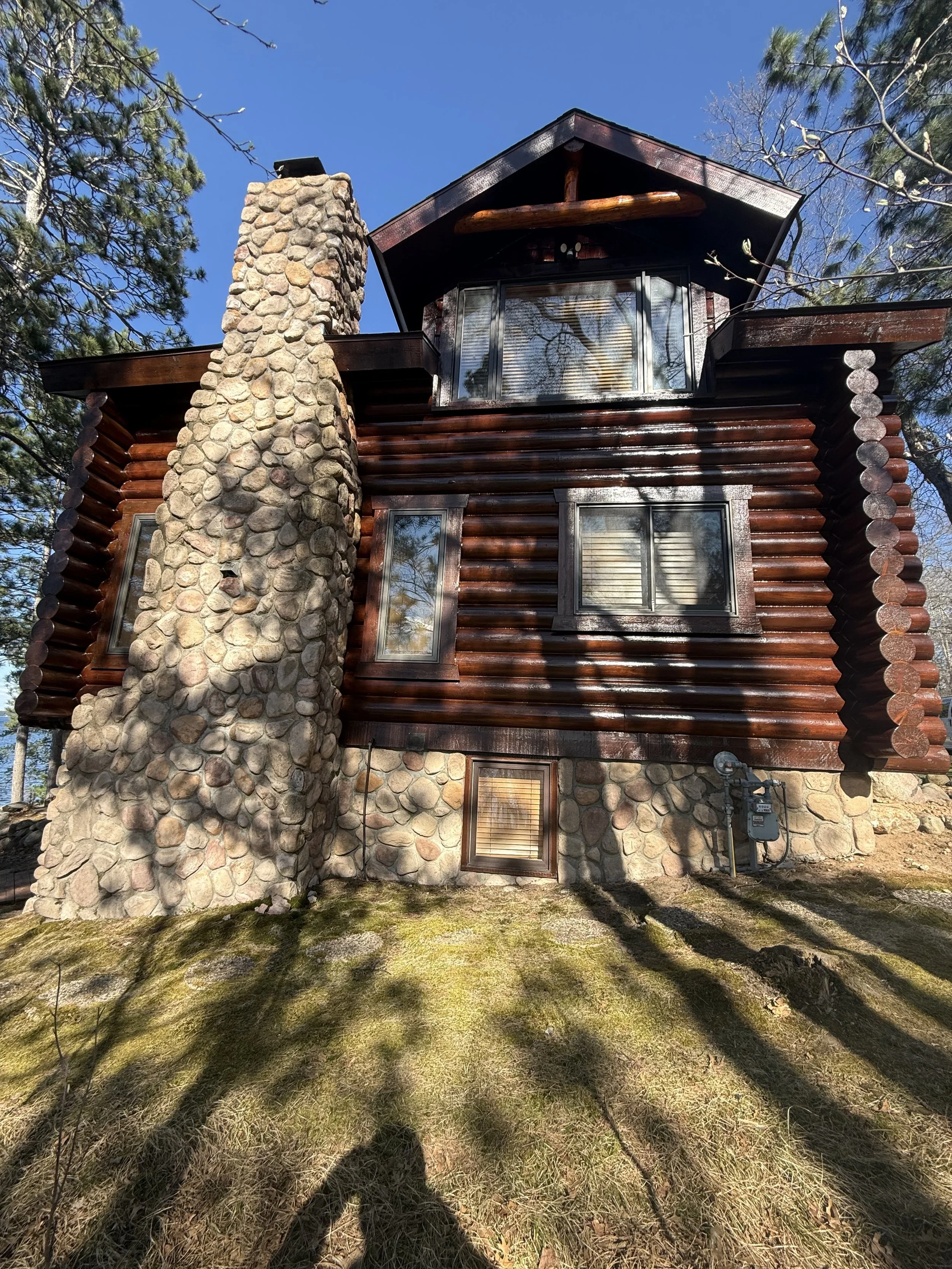 log cabin with dark stain in brainerd lakes area minnesota