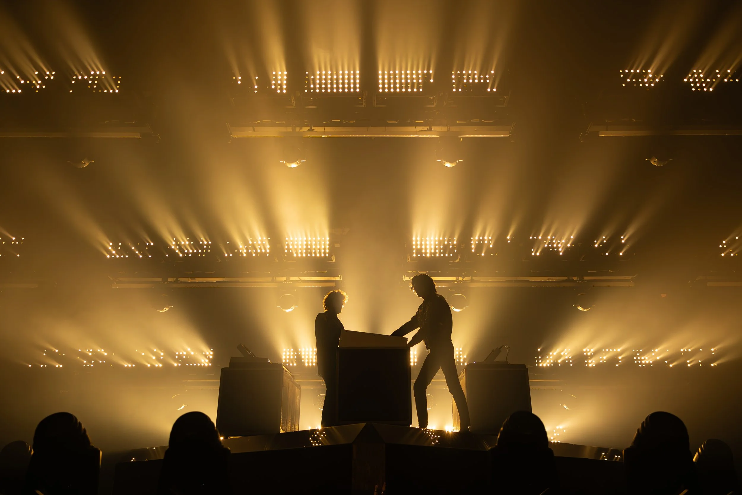 Gaspard Augé & Xavier de Rosnay of Justice.
Stage illuminated by warm yellow sparkling light