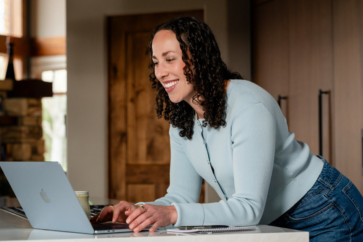 Natalie Youssef working on her laptop — performance and health coaching at Thrive With You
