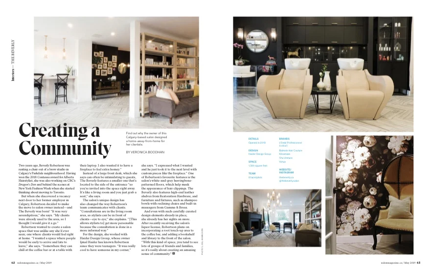 Interior design of a salon with chairs, salon sinks, a sitting area with a couch, and decorative floral arrangements.