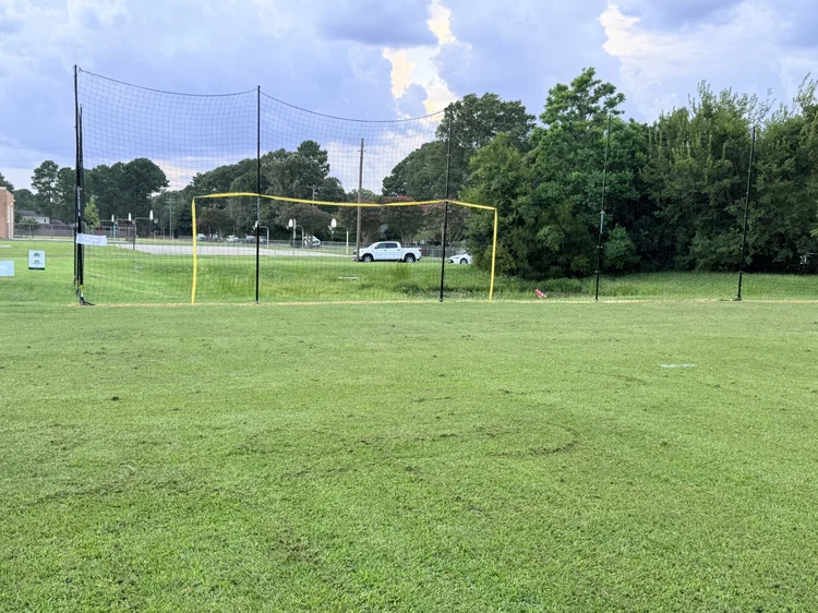 The Great Neck Pitch at Great Neck Baptist Church, with For the Players Foundation and Great Neck Baptist Church banners on the backstop netting