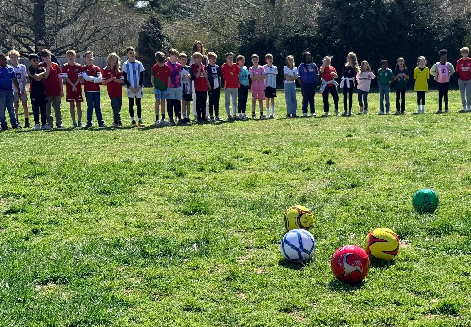 Kids and soccer balls out on the field