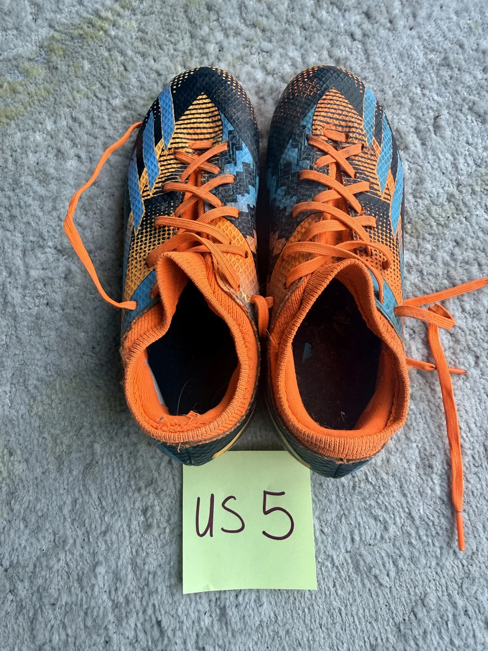 Orange/blue/black cleats, US 5