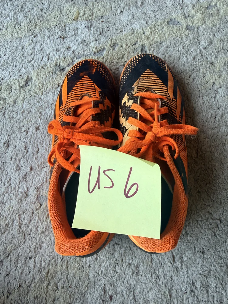 Orange/black cleats, US 6