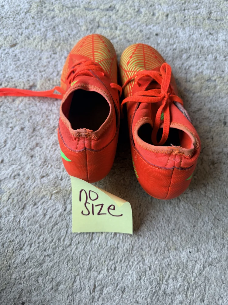 Adidas orange/green cleats, size unknown