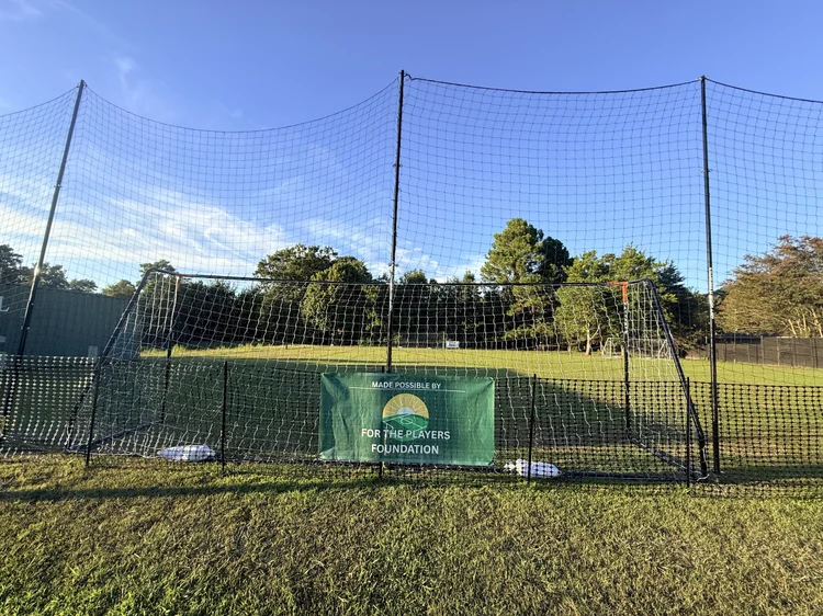 The Great Neck Pitch at Great Neck Baptist Church, with For the Players Foundation and Great Neck Baptist Church banners on the backstop netting