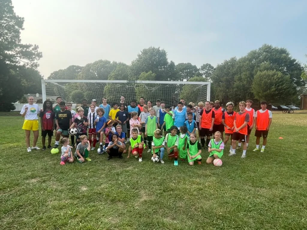 The whole group of players, volunteers, and coaches at free pickup soccer