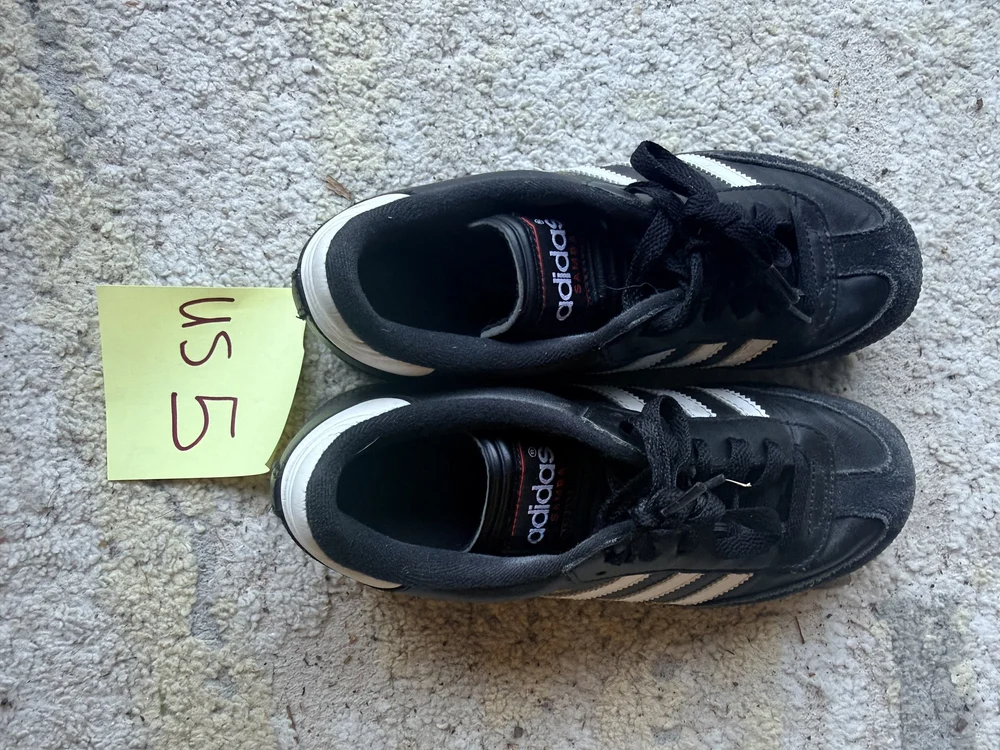 A gently used pair of donated soccer cleats, cleaned and ready for a new player