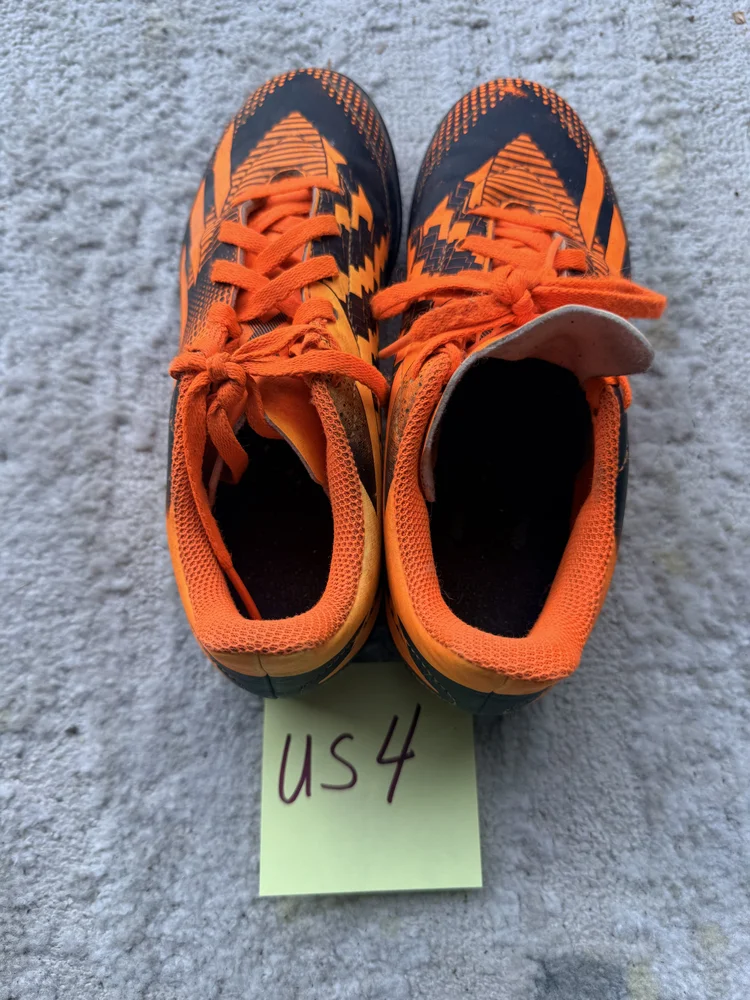 Orange/black cleats, US 4
