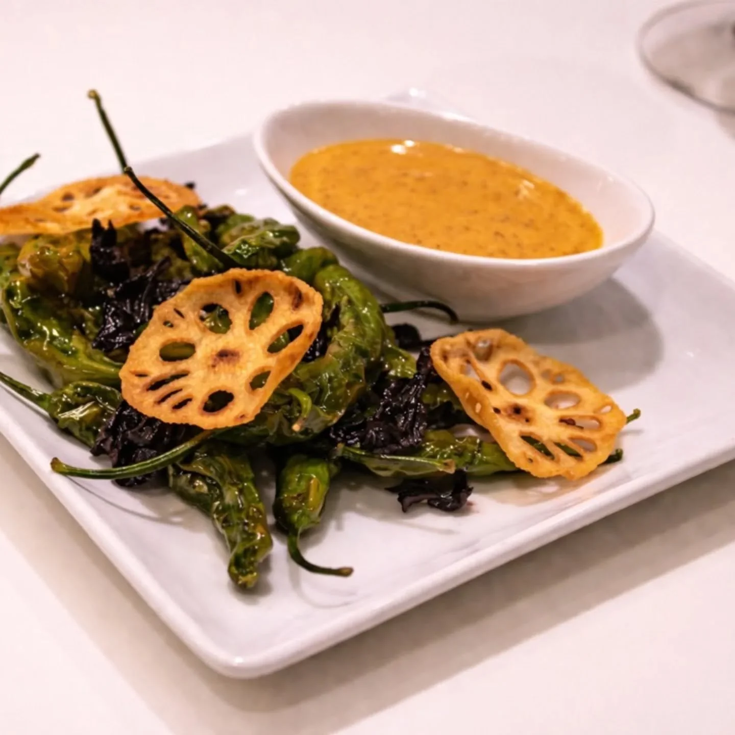 Blistered shishito peppers 🌶️
Candied hibiscus, crisp lotus root chips, with a coffee ancho emulsion.
Sweet, smoky, bitter, and bright&mdash;this dish hits every note and lingers in the best way.

#Balandra #SeattleEats #SmallPlates #ShishitoPeppers