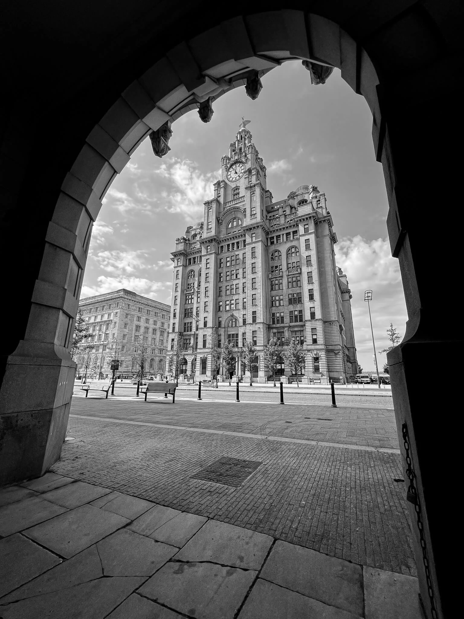Black and white photo of the Liver building in Liverpool framed by an arch