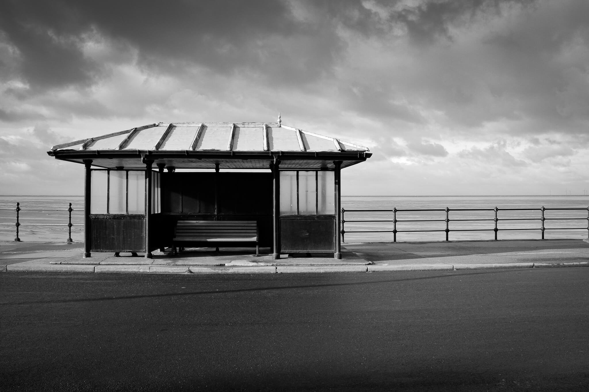 Black and white photo of shelter on a beach promenade