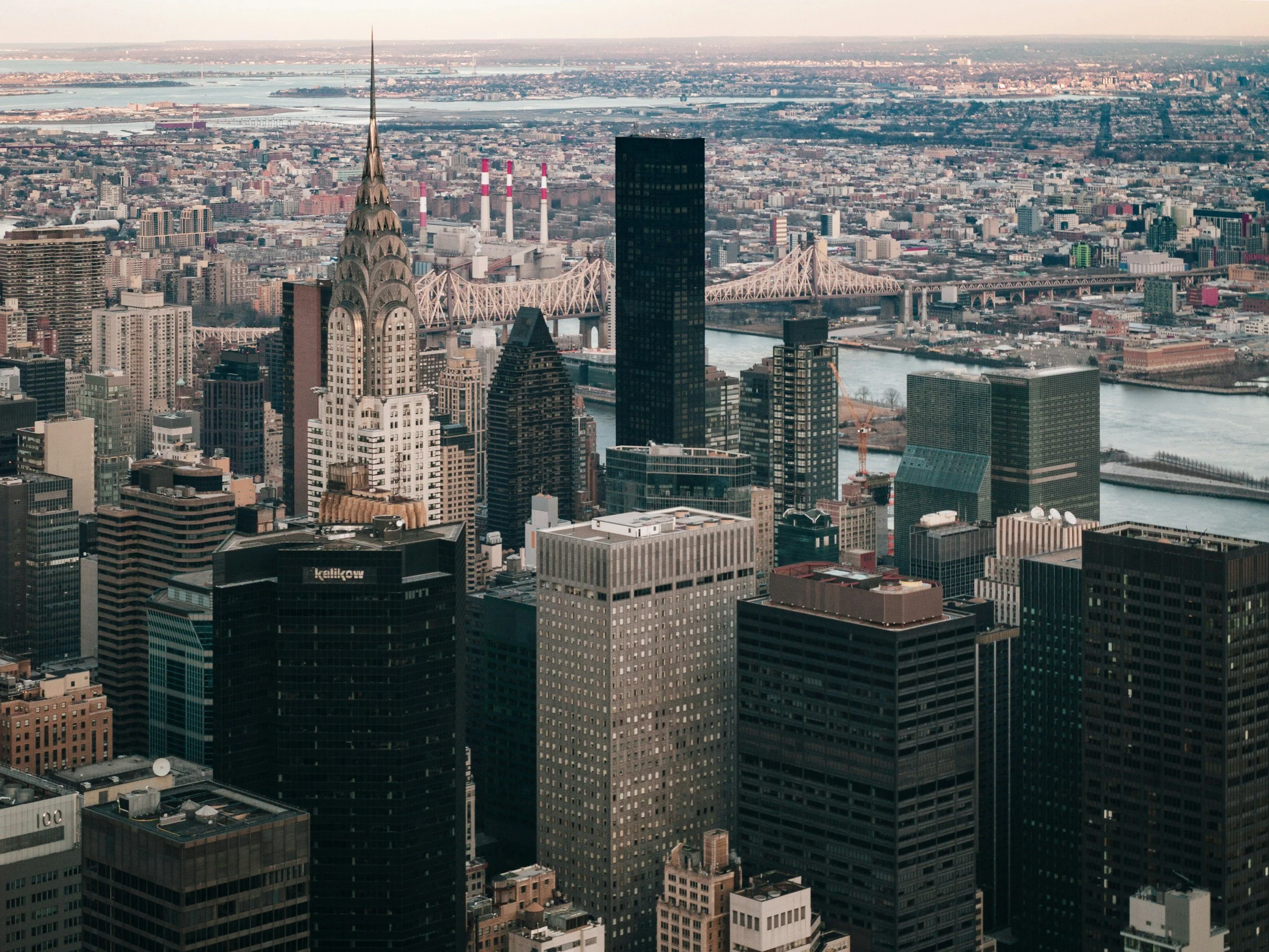 Aerial view of Manhattan skyline with skyscrapers, the Chrysler Building, and East River in New York City.