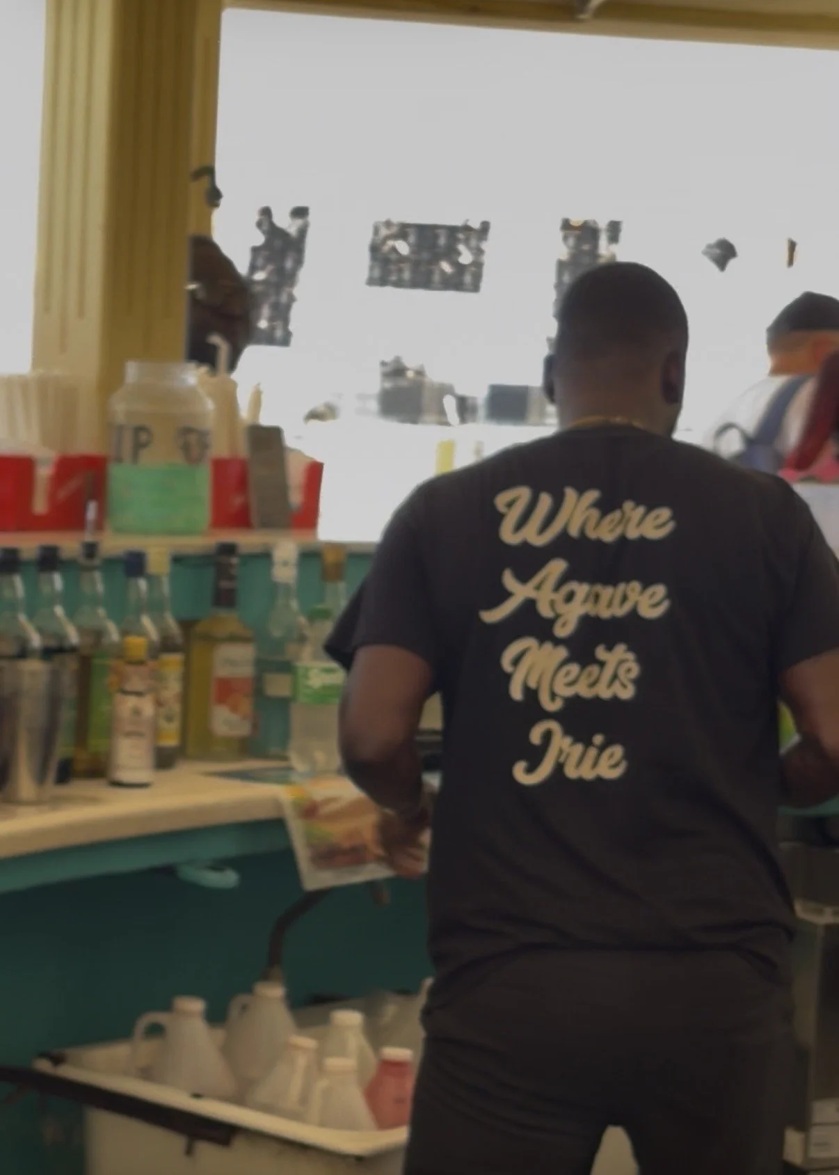 A bartender wearing a Casa JAMEX shirt working behind a bar